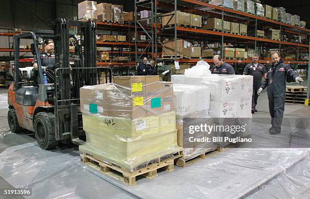 Cargo employees prepare a pallot full of AmeriCares medical and humanitarian supplies for victims of the Indian Ocean tsunami to be loaded onto a NWA...