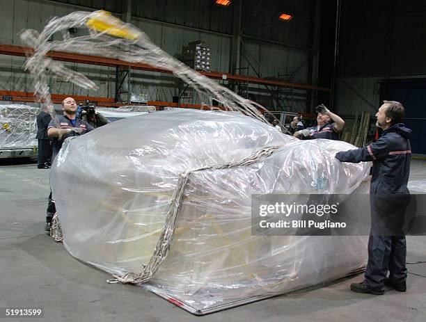 Cargo employees prepare a pallot full of AmeriCares medical and humanitarian supplies for victims of the Indian Ocean tsunami at Detroit Metropolitan...