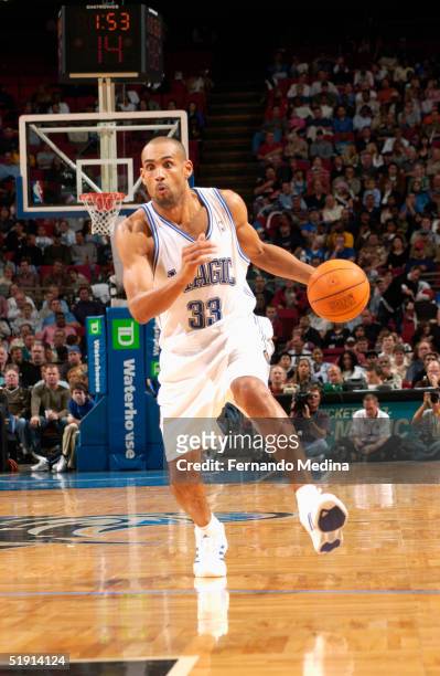 Grant Hill of the Orlando Magic moves the ball during the game with the Memphis Grizzlies at TD Waterhouse Centre on December 4, 2003 in Orlando,...