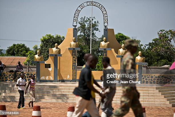Soldiers and civilians walk past the Garden of Semicentennial, a small park celebrating the 50th anniversary of the independence of Central African...