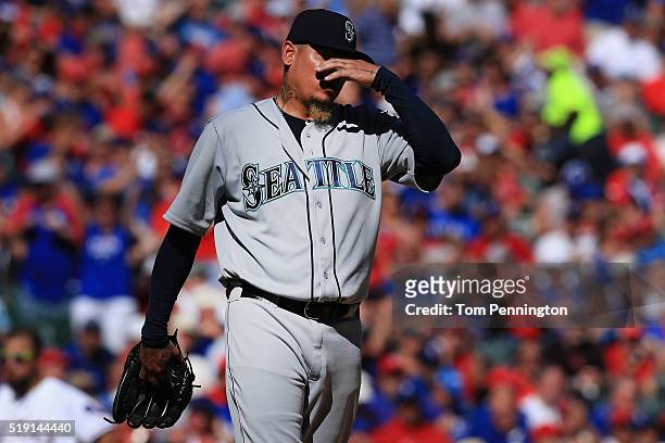 Felix Hernandez of the Seattle Mariners reacts after giving up a run against the Texas Rangers in the bottom of the fifth inning on Opening Day at...