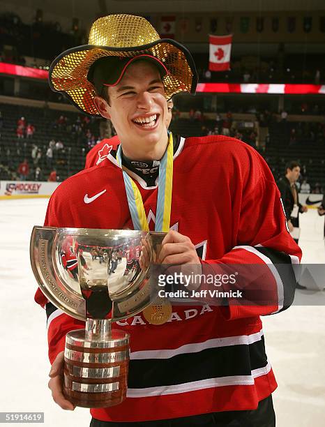 Sidney Crosby of Canada holds the World Junior Championship trophy after Canada defeated Russia 6-1 at the World Junior Hockey Championships on...