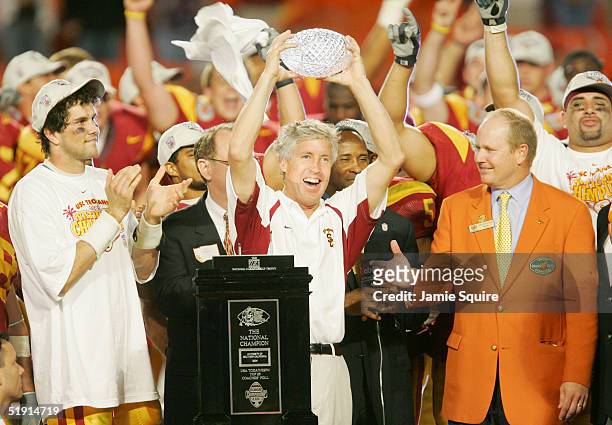 Head coach Pete Carroll and quarterback Matt Leinart of the USC Trojans celebrate with the championship trophy after defeating the Oklahoma Sooners...