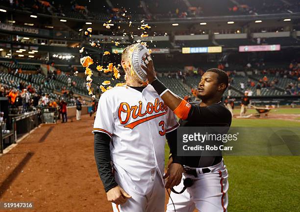 Adam Jones hits Matt Wieters of the Baltimore Orioles in the face with pie after the Orioles defeated the Minnesota Twins 3-2 during their Opening...