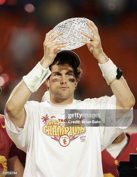 Quarterback Matt Leinart of the USC Trojans holds up the championship trophy after defeating the Oklahoma Sooners 55-19 to win the FedEx Orange Bowl...