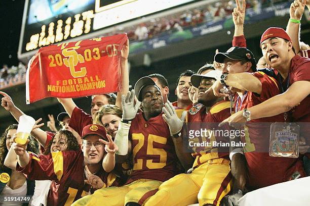 Eric Wright and Desmond Reed of the USC Trojans celebrate in the stands after defeating the Oklahoma Sooners 55-19 to win the FedEx Orange Bowl 2005...