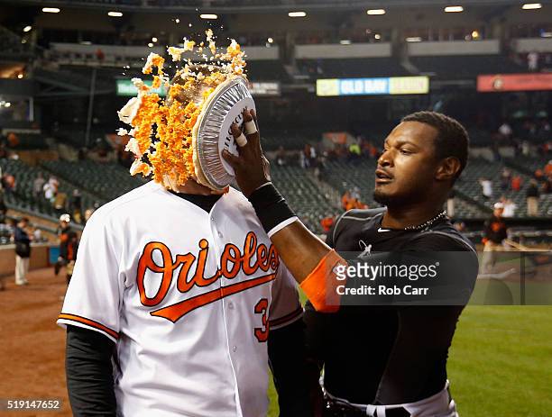 Adam Jones hits Matt Wieters of the Baltimore Orioles in the face with pie after the Orioles defeated the Minnesota Twins 3-2 during their Opening...