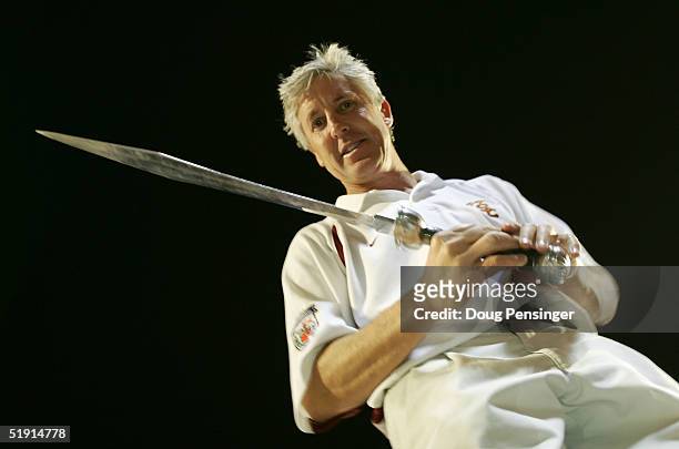 Head coach Pete Carroll of the USC Trojans holds the sword he used to direct the band after defeating the Oklahoma Sooners 55-19 to win the FedEx...