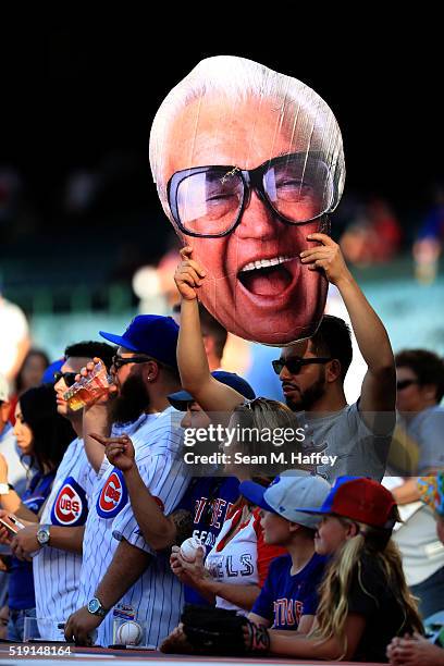Chicago Cubs fan holds a picture of Harry Caray during warmups prior to the Opening Day game between the Los Angeles Angels and Chicago Cubs at Angel...