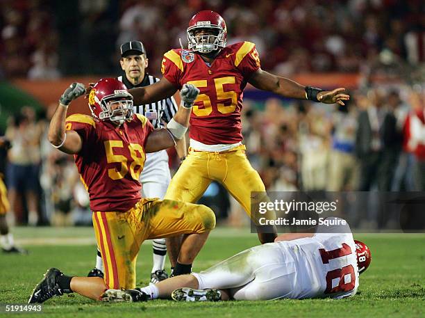 Keith Rivers and Lofa Tatupu of the USC Trojans celebrate after sacking Jason White of the Oklahoma Sooners in the third quarter during the FedEx...