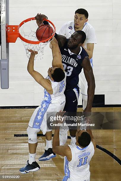 Daniel Ochefu of the Villanova Wildcats dunks the ball against Marcus Paige of the North Carolina Tar Heels in the first half during the 2016 NCAA...