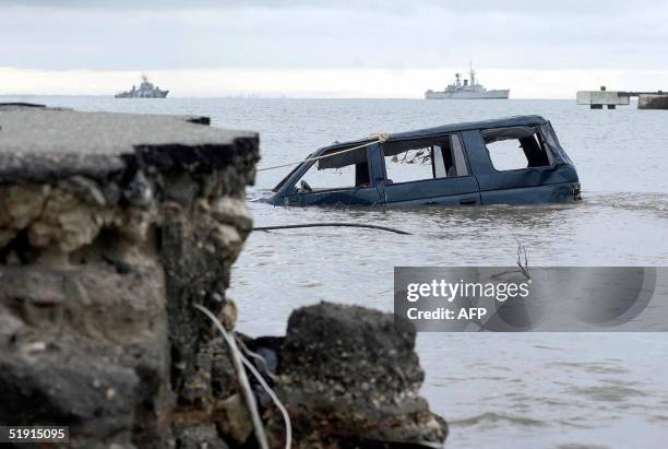 Car remains in the water more than a week after an earthquake and tsunami hit Aceh province, in Meulaboh, 04 January 2005. Indonesia's new leader was...