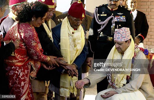 Nepal's King Gyanendra receives holy water from a Buddhist Priest in a traditional ceremony at Narayanhity Royal Palace in Kathmandu,05 January 2005....