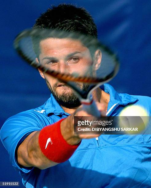 French tennis player Olivier Patience plays a forehand shot during his second round match against Czech Republic player Michal Tabara in the Chennai...