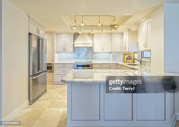 beautiful remodeled kitchen in a condominium - cabinet stock pictures, royalty-free photos & images