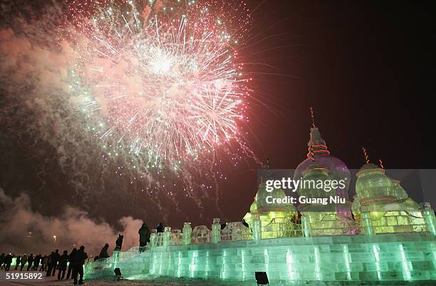 Fireworks explode in the air above ice carvings during the opening ceremony of the Ice and Snow Festival January 5, 2005 in Harbin, China. The event,...
