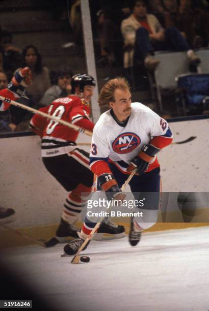 Swedish professional hockey player Bob Nystrom forward of the New York Islanders skates by Canadian hockey player Denis Savard forward of the Chicago...
