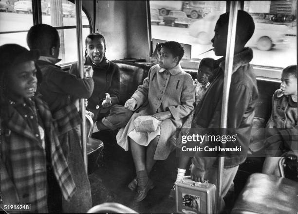 Linda Brown and her sister Terry Lynn sit on a bus as they ride to the racially segregated Monroe Elementary School, Topeka, Kansas, March 1953. The...
