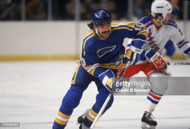 Canadian professional hockey player Wayne Babych forward of the St. Louis Blues skates up the ice as Don Maloney forward of the New York Rangers...