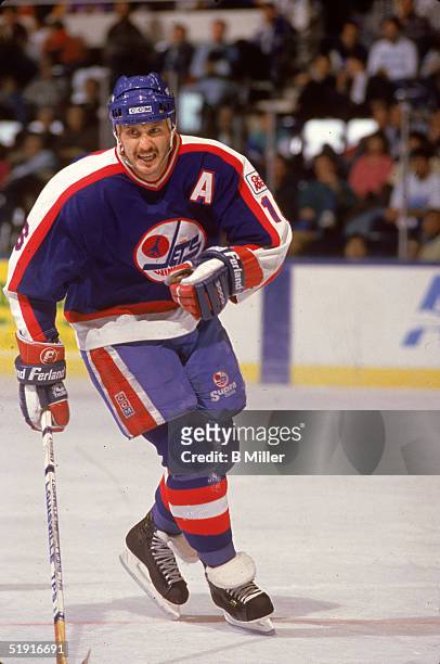 Canadian professional hockey player Laurie Boschman forward of the Winnipeg Jets skates on the ice during a road game against the New York Islanders,...