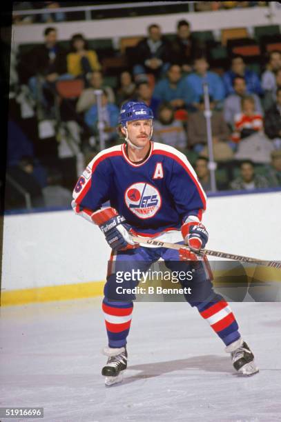 Canadian professional hockey player Laurie Boschman forward of the Winnipeg Jets skates on the ice during a road game against the New York Islanders,...