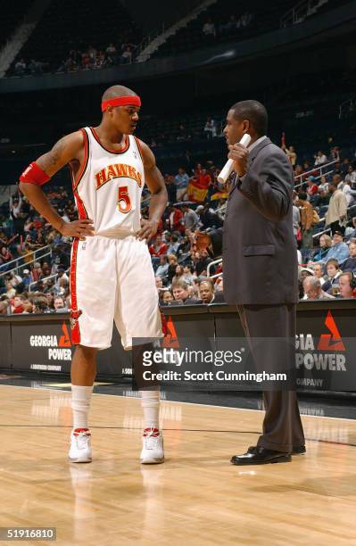 Josh Smith of the Atlanta Hawks talks to his head coach Larry Drew during the game against the Memphis Grizzlies on December 8, 2004 at Philips Arena...