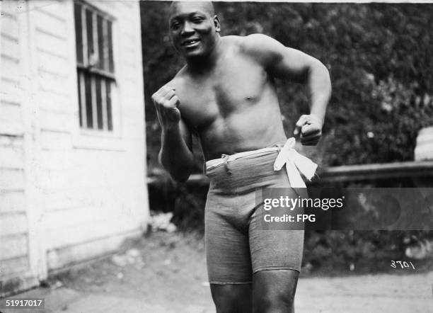 American boxer Jack Johnson , the world heavyweight champion, in a boxing stance, early 1910s.
