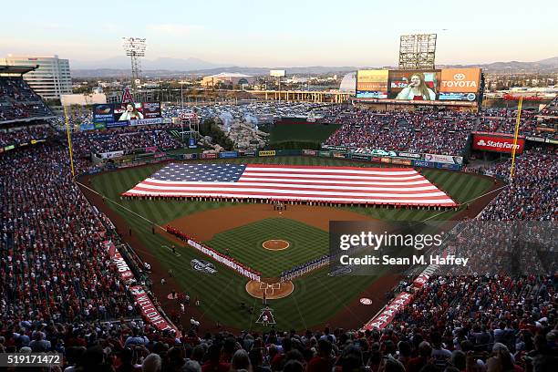 Players line the field during pre-game festivities on Opening Day before a baseball game between the Los Angeles Angels and Chicago Cubs at Angel...