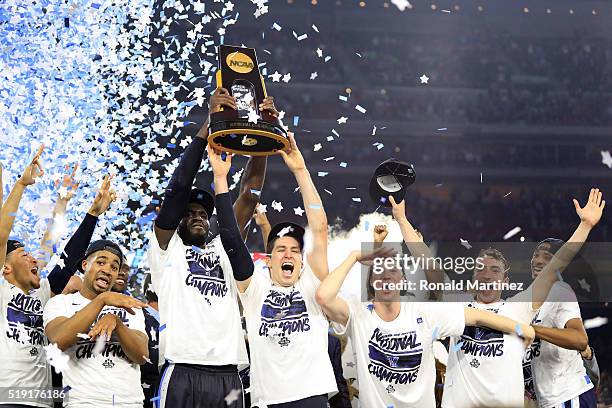 Daniel Ochefu of the Villanova Wildcats and Ryan Arcidiacono hoist the trophy after the Villanova Wildcats defeat the North Carolina Tar Heels 77-74...