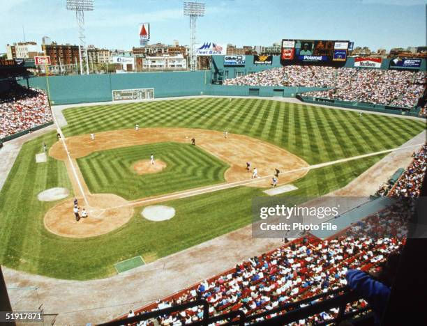 View of a baseball game between the Boston Red Sox and the Toronto Blue Jays, and of the Green Monster left-field wall, from the upper deck at Fenway...