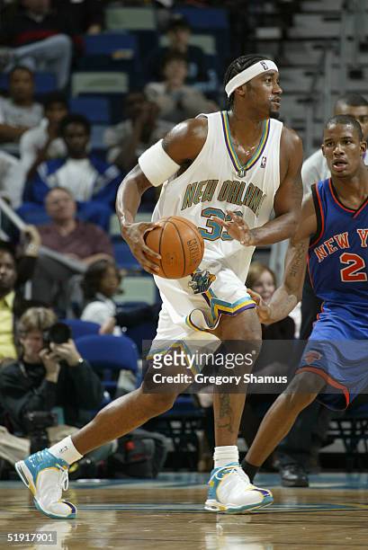 Lee Nailon of the New Orleans Hornets drives against the New York Knicks during the game at the New Orleans Arena on December 8, 2004 in New Orleans,...