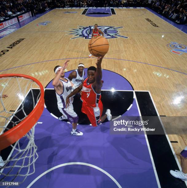 Kareem Rush of the Charlotte Bobcats lays up a shot against Brad Miller of the Sacramento Kings during a game at Arco Arena on December 7, 2004 in...