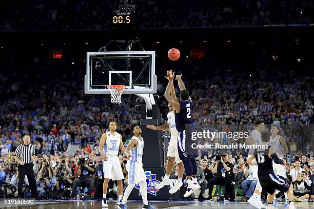 Kris Jenkins of the Villanova Wildcats shoots the game-winning three pointer to defeat the North Carolina Tar Heels 77-74 in the 2016 NCAA Men's...