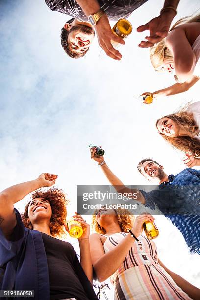 friends having fun and drinking some beers outdoor - aperitif stock pictures, royalty-free photos & images