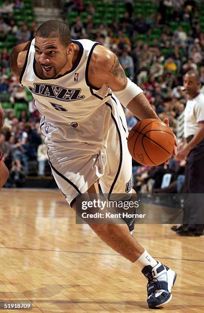 Carlos Boozer of the Utah Jazz drives against the Philadelphia 76ers on January 5, 2005 at the Delta Center in Salt Lake City, Utah. NOTE TO USER:...