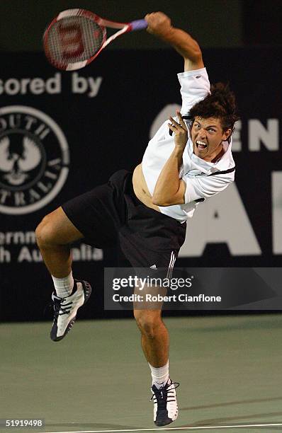 Taylor Dent of the USA serves to Julien Bennetau of France during the singles match on day four of the Next Generation Men's Hardcourts at Memorial...