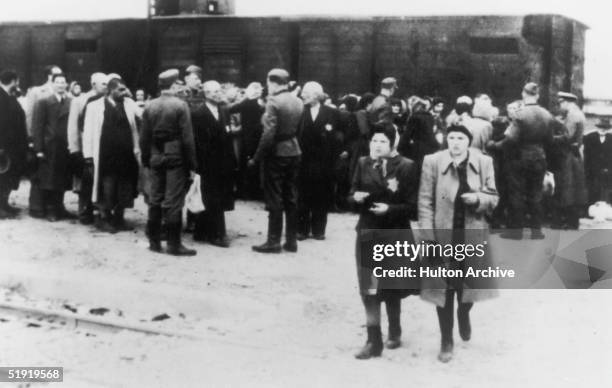 Newly arrived deportees and guards at the Nazi concentration camp at Auschwitz, Poland, circa 1943.