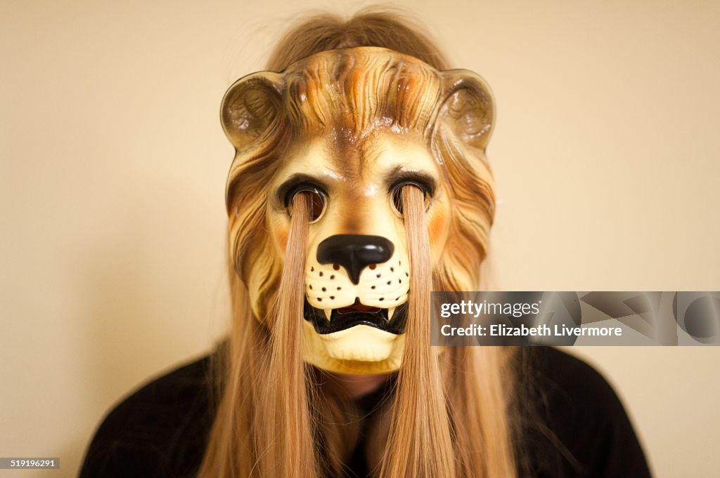 Blonde woman wearing lion mask