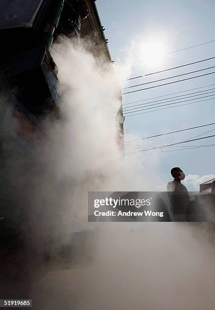 Thai soldiers unload dry ice in order to preserve the bodies of tsunami victims at a makeshift morgue at a temple on January 6, 2005 in Takua Pa,...