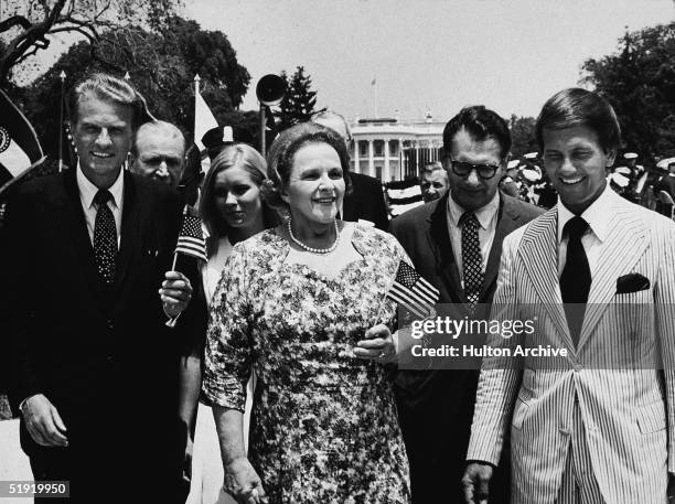 Front row from left, American evangelical preacher Billy Graham, singer Kate Smith , Dr. E. Harrison, and singer Pat Boone, celebrate 'Honor America...