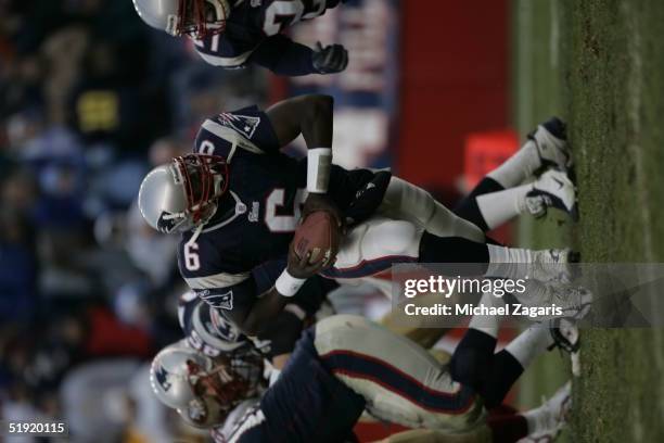 Rohan Davey of the New England Patriots prepares to hand off the ball against the San Francisco 49ers at Gillette Stadium on January 2, 2004 in...