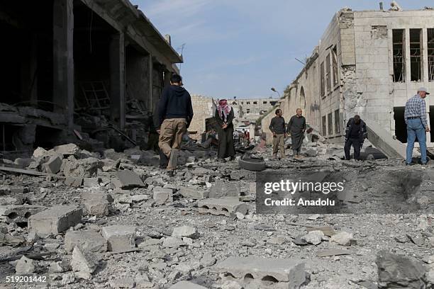 People inspect the damage at the site of a car bombing attack killing at least two people and injuring six at a market in Maarat al-Numan of Idlib,...