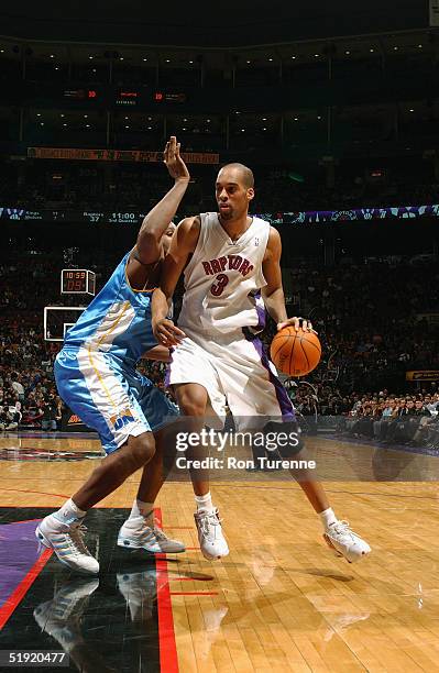 Loren Woods of the Toronto Raptors drives to the basket during the game against the Denver Nuggets at Air Canada Centre on December 10, 2004 in...