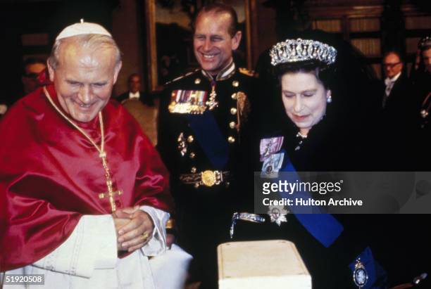 Queen Elizabeth II and her husband Prince Philip, Duke of Edinburgh with Pope John Paul II during the royal tour of Italy, 1980.