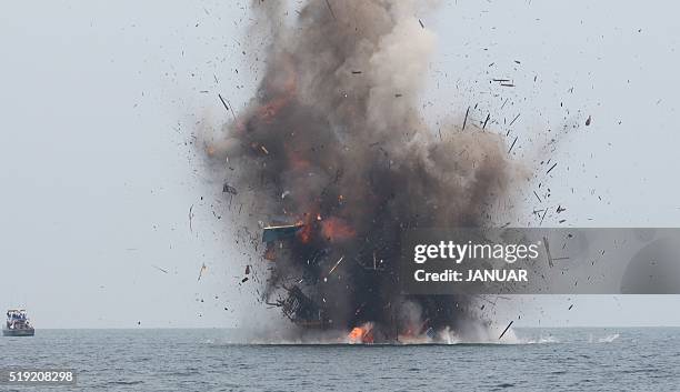 An illegal fishing boat is blown up with explosives by Indonesian authorities in Kuala Langsa, Aceh province on April 5, 2016. Indonesia sank 28...