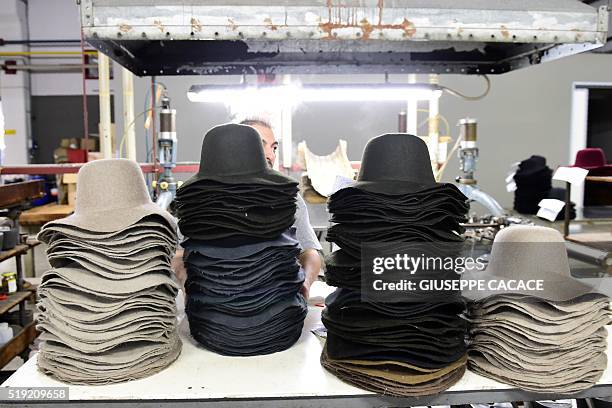 An employee works at the Borsalino hat company's factory in Alessandria on March 30, 2016. A group of investors is determined to revive the legendary...