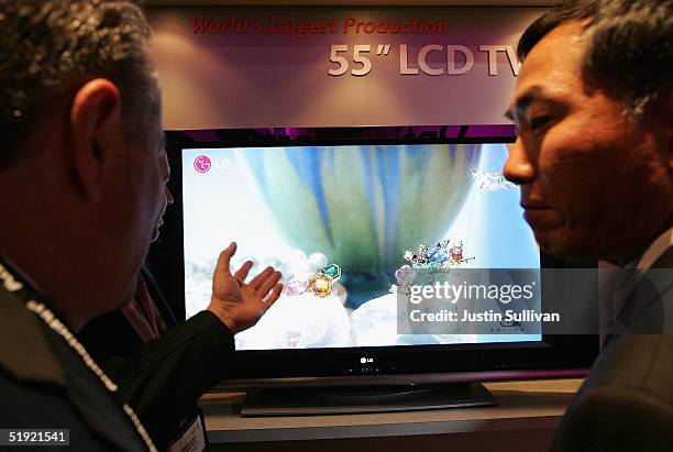 Two men look at an LG 55" LCD TV on display at the 2005 Consumer Electronics Show January 6, 2005 in Las Vegas, Nevada. The 1.5 million square foot...