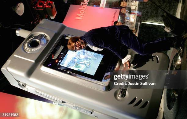 An Austin Powers impersonator hugs a giant LG cell phone at the 2005 Consumer Electronics Show January 6, 2005 in Las Vegas, Nevada. The 1.5 million...