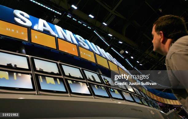 Man looks at a display of Samsung flat panel televisions at the 2005 Consumer Electronics Show January 6, 2005 in Las Vegas, Nevada. The 1.5 million...