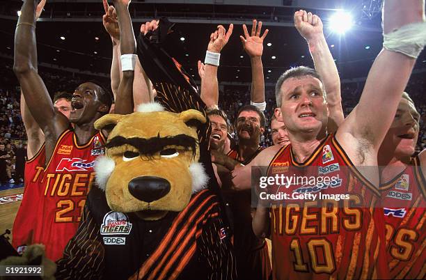 Andrew Gaze of the Tigers celebrates with the team after winning the 1997 NBL Final between the Melbourne Tigers and South East Melbourne Magic...